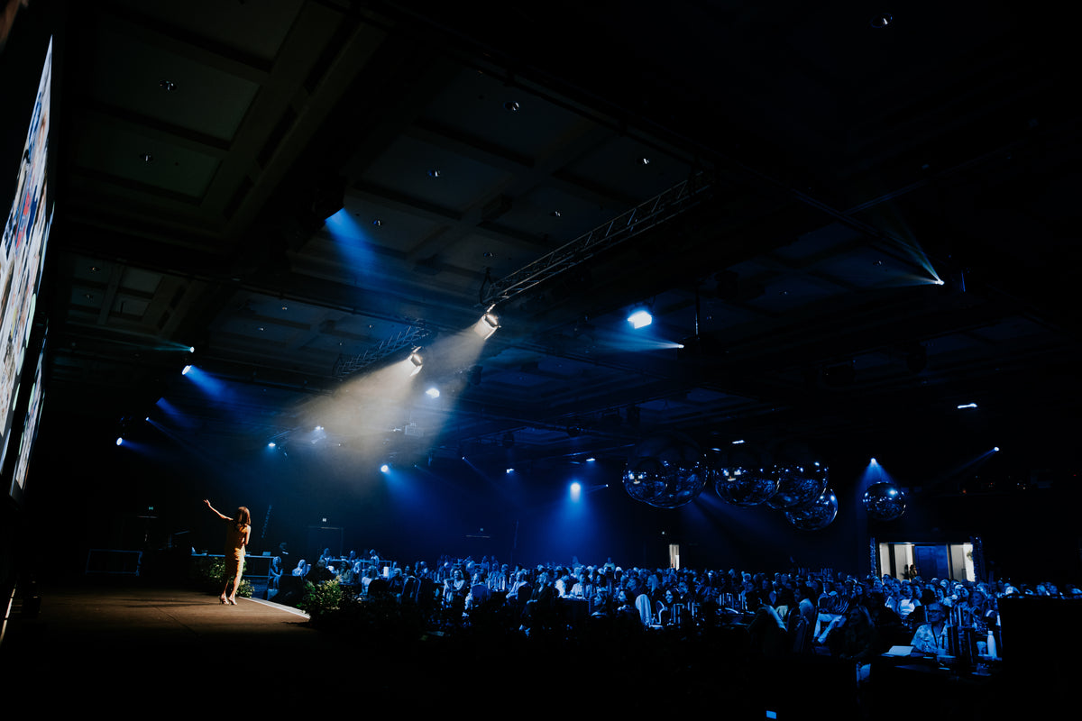 Conference stage and audience at the Modere Putting Health at the Top event