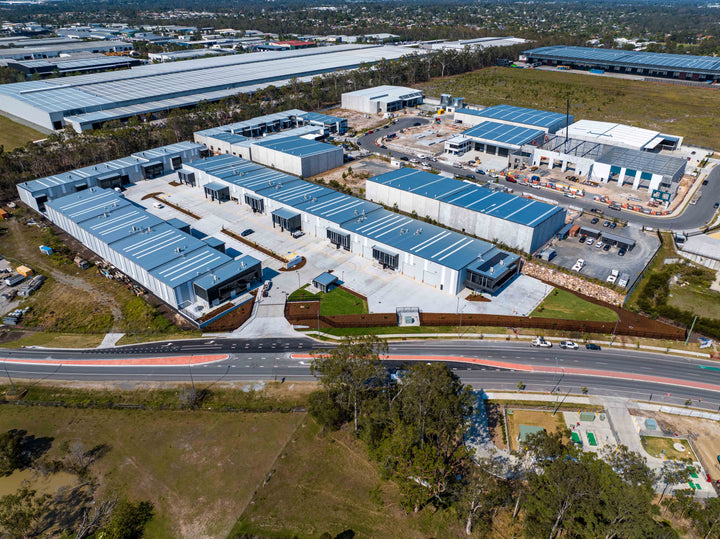 Alternate drone image showing construction progress at a commercial development site